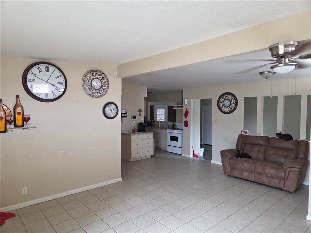 4845 Monitor Street Corpus Christi, TX 78415 - Photo 7 of 16 a living room with furniture a clock and a large window