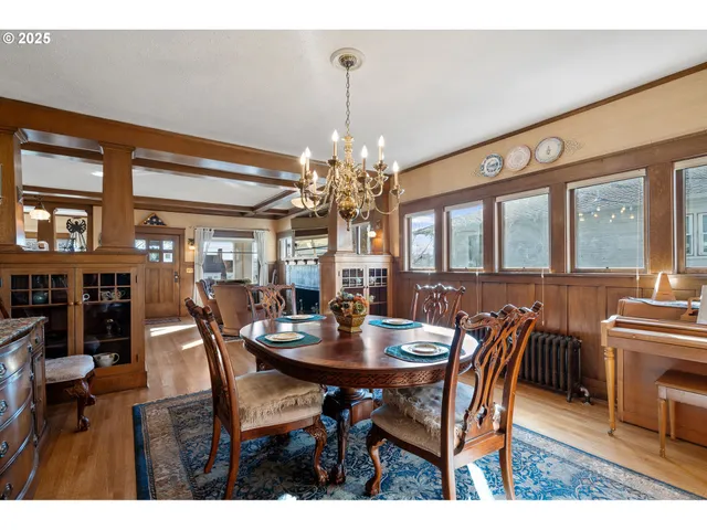a view of a dining room with furniture and chandelier