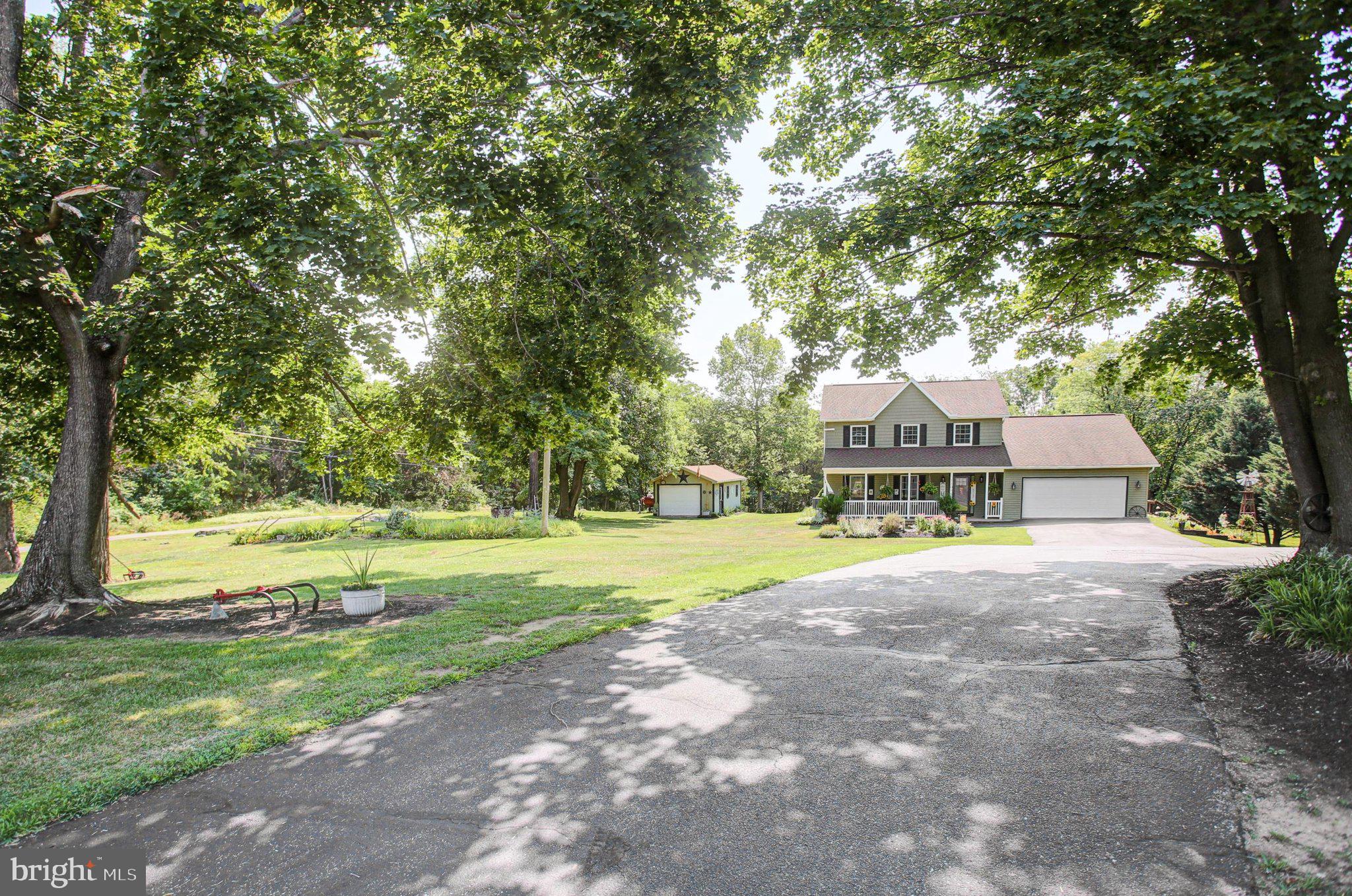 11086 Welsh Run Road Greencastle, PA 17225 - Photo 2 of 63 a front view of a house with a yard and large trees