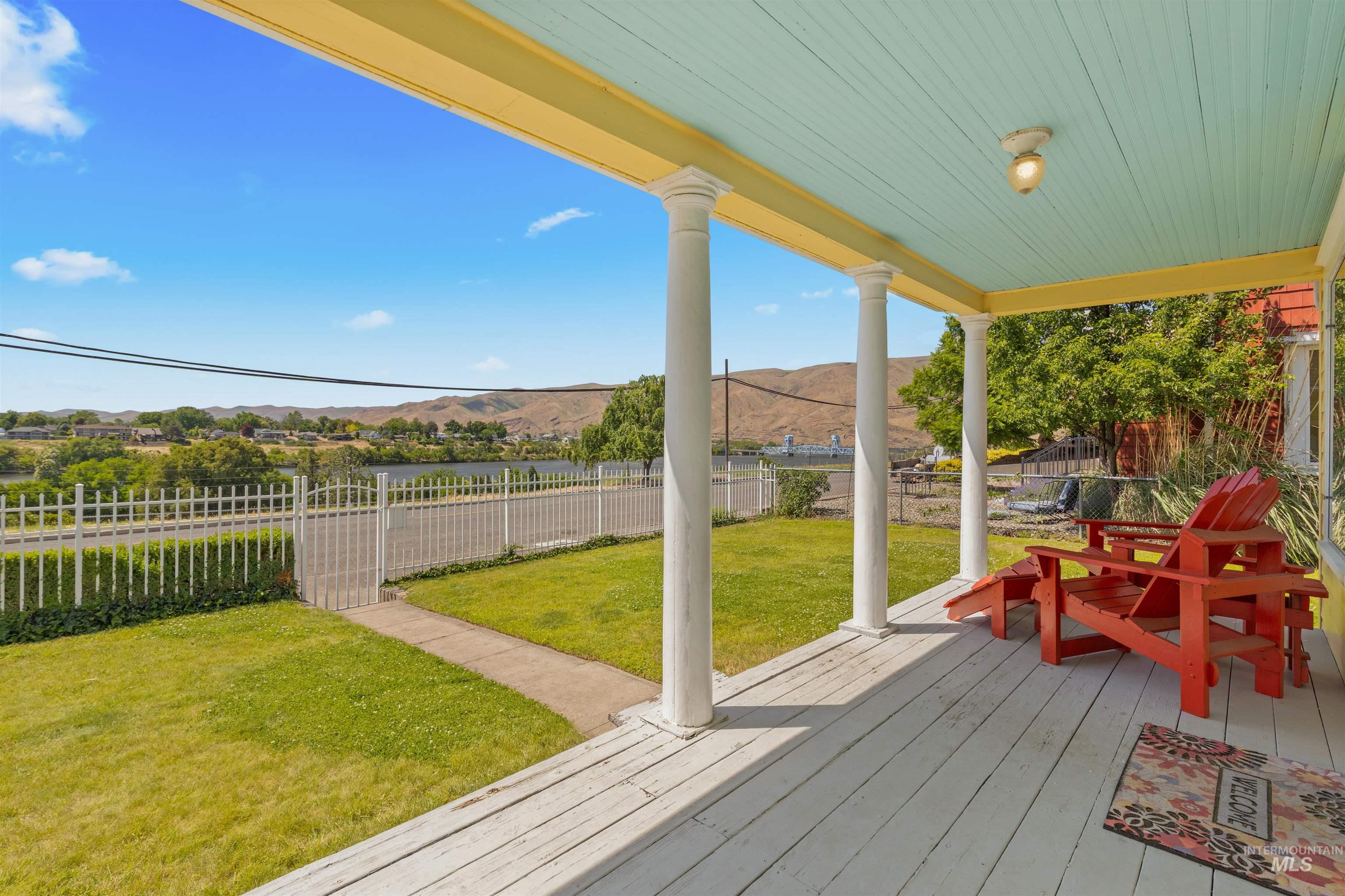 619 Prospect Avenue Lewiston, ID 83501 - Photo 3 of 37 Covered front porch featuring white wood-plank flooring, white architectural columns, and a light blue painted tongue-and-groove ceiling with a surface-mounted light fixture