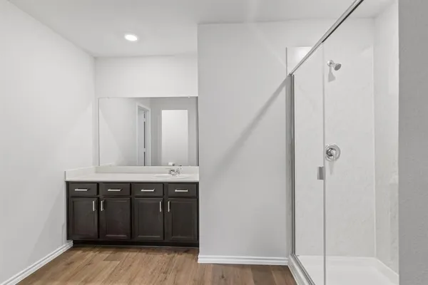 a bathroom with a glass shower door