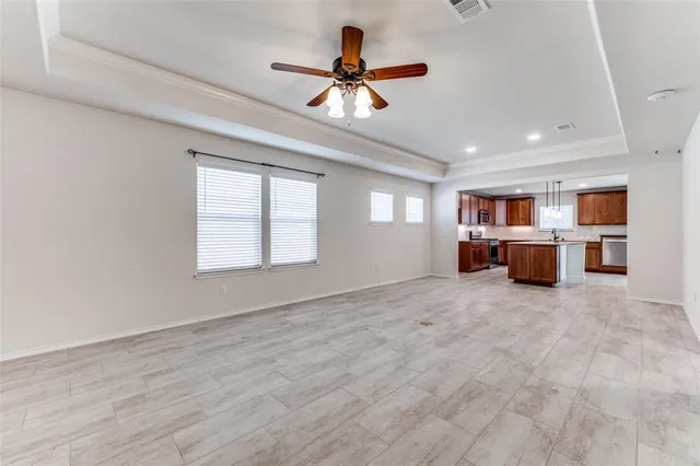 a view of a livingroom with a window and a ceiling fan