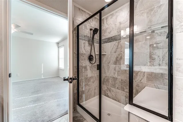 a bathroom with a glass shower door