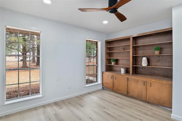 a kitchen with stainless steel appliances a large window and cabinets