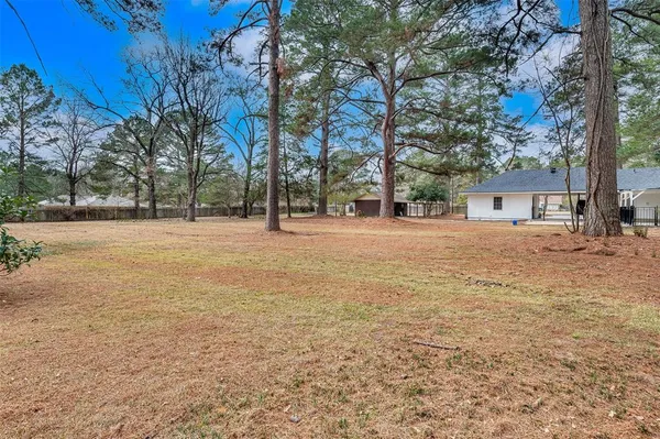 a backyard of apartments with large trees