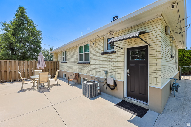 59 East 8680th Street South Sandy, UT 84070 - Photo 27 of 33 Expansive concrete patio bordered by a wood privacy fence