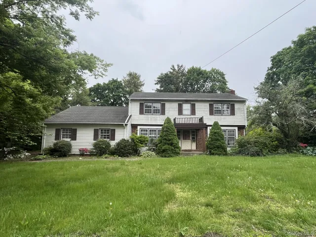 a view of house with yard and green space