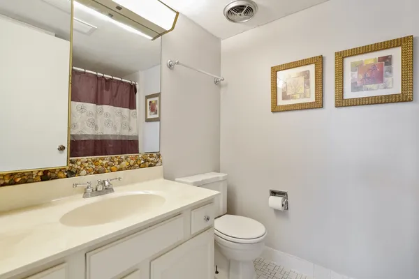 a bathroom with a sink toilet and a mirror
