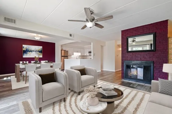 a living room with furniture a fireplace and a flat screen tv