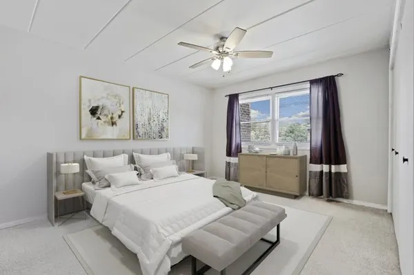 a bedroom with a large bed and a window