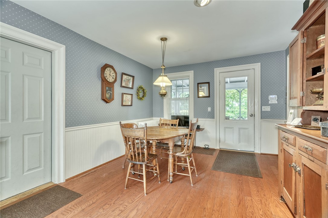 1479 Creek Street Rochester, NY 14625 - Photo 21 of 50 KITCHEN DINING AREA - HARDWOODS - DOOR TO SCREENED