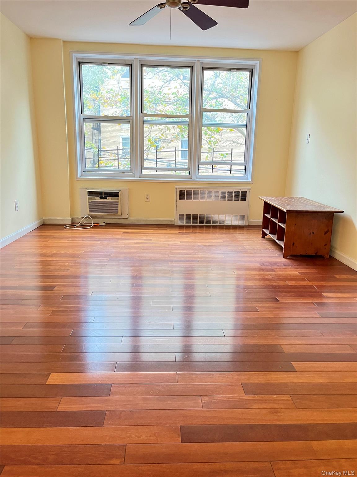 142-15 Franklin Avenue, Unit 3F Queens, NY 11355 - Photo 12 of 15 Spare room featuring radiator heating unit and light wood-type flooring