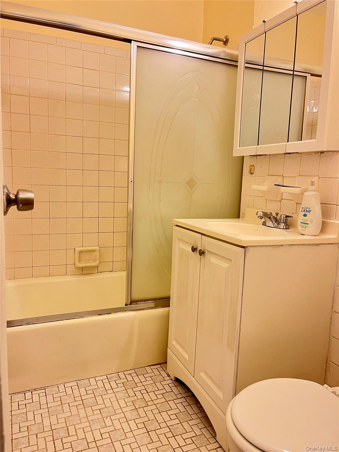 142-15 Franklin Avenue, Unit 3F Queens, NY 11355 - Photo 7 of 15 Full bath featuring combined bath / shower with glass door, vanity, and backsplash