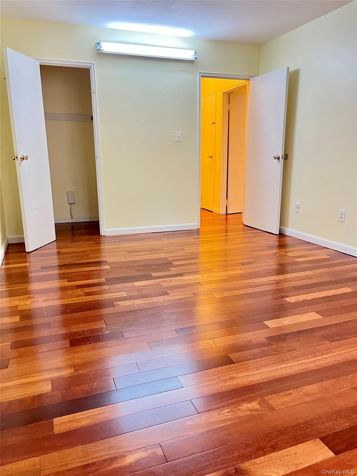 142-15 Franklin Avenue, Unit 3F Queens, NY 11355 - Photo 10 of 15 Unfurnished bedroom with light wood-style flooring and a closet