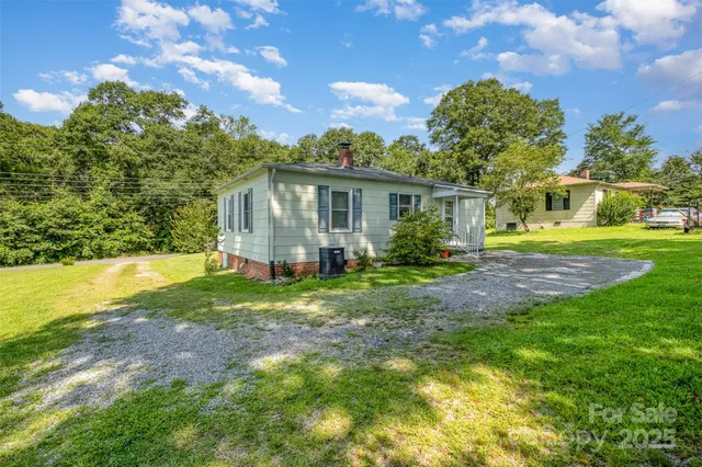 a view of a house with yard and a garden