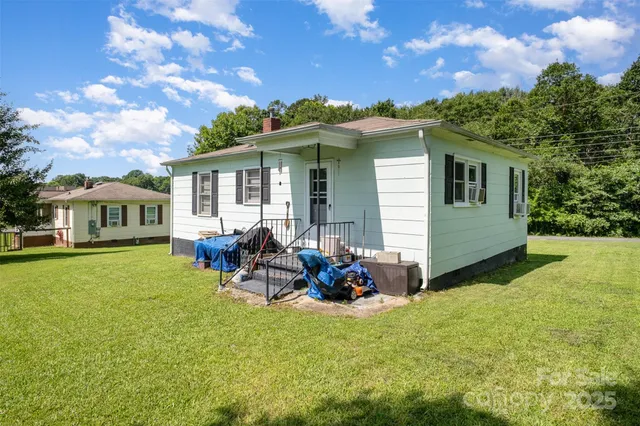 a backyard of a house with table and chairs