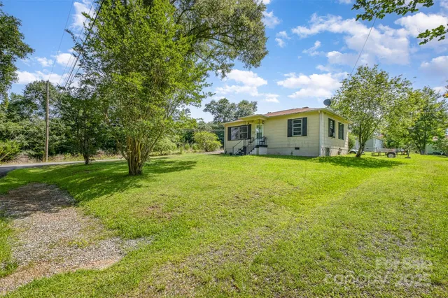 a view of a house with backyard and a slide