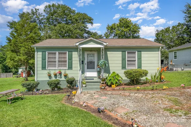 a front view of a house with a garden