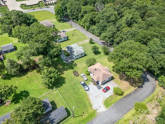 an aerial view of residential house with outdoor space and swimming pool
