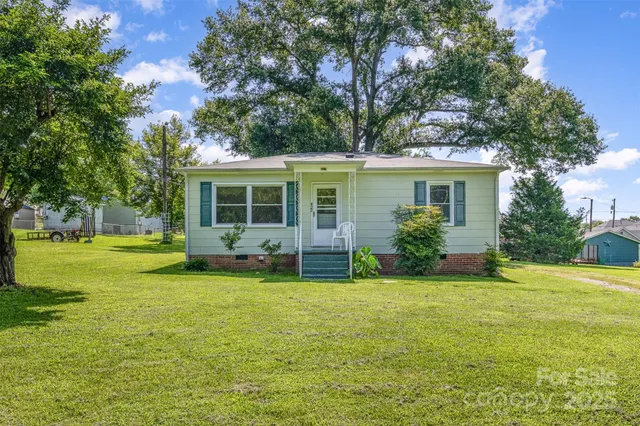 a view of a house with a yard porch and sitting area