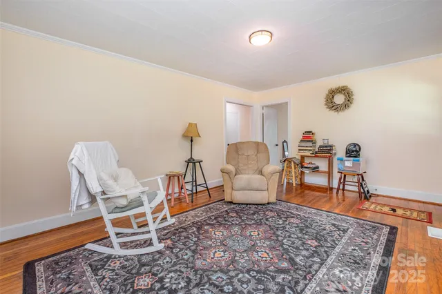 a living room with furniture a rug and a table