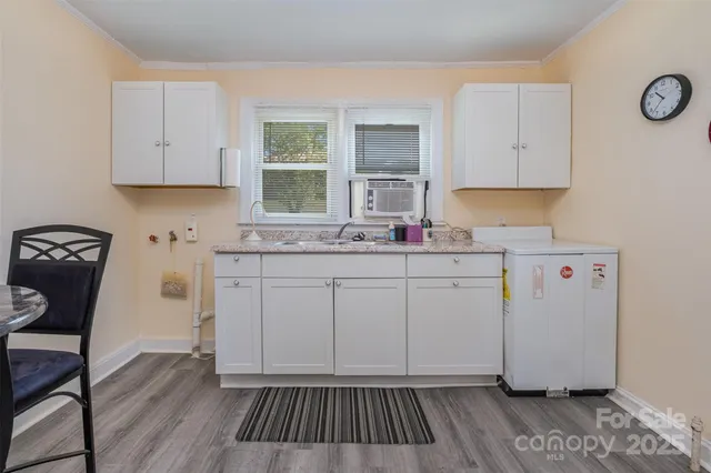 a kitchen with sink cabinets and wooden floor