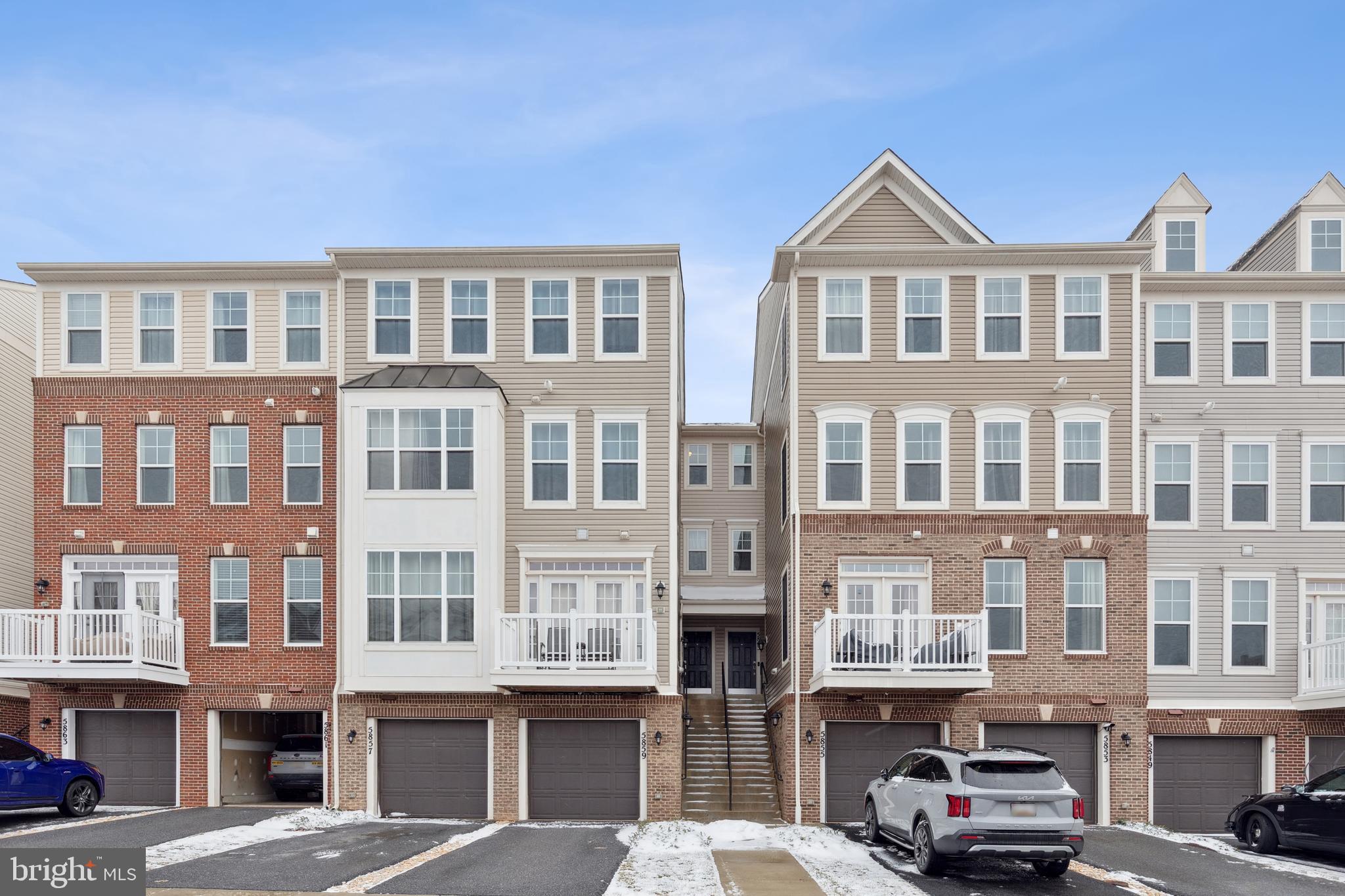 5857 Bella Marie Way, Unit F Frederick, MD 21703 - Photo 1 of 45 a front view of a residential apartment building with a yard