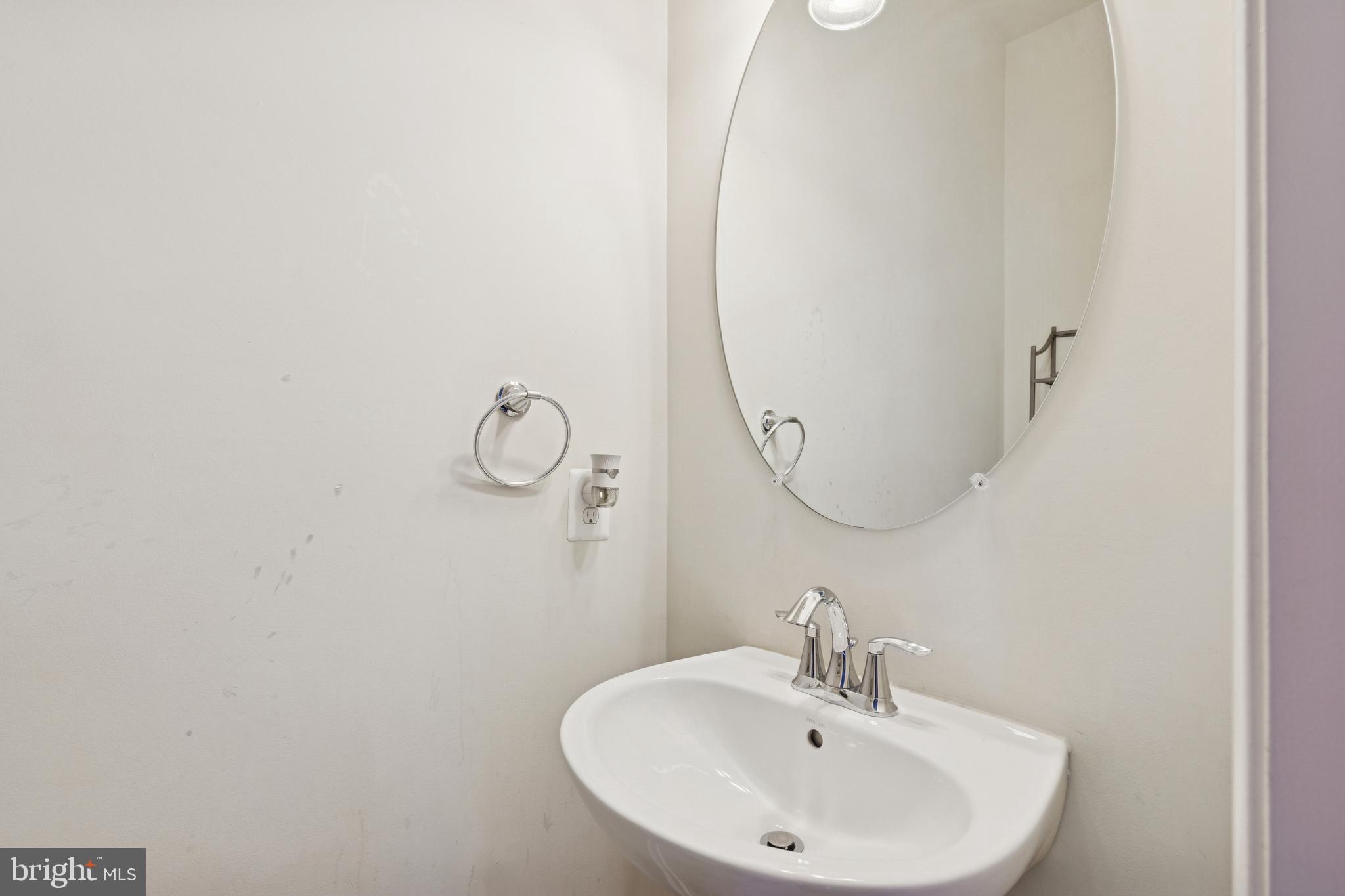 5857 Bella Marie Way, Unit F Frederick, MD 21703 - Photo 12 of 45 a bathroom with a sink and mirror