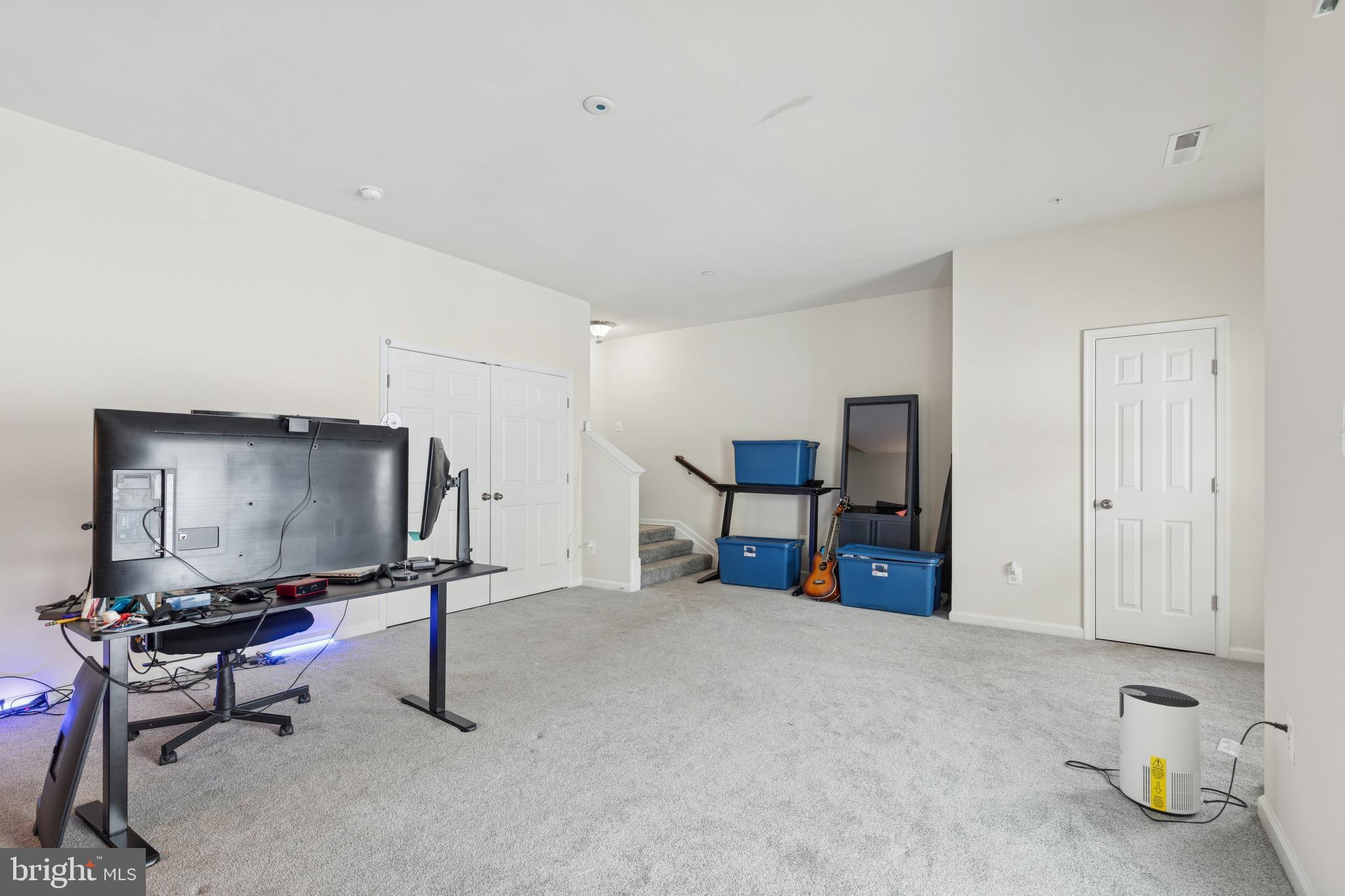 5857 Bella Marie Way, Unit F Frederick, MD 21703 - Photo 14 of 45 a living room with furniture and a flat screen tv