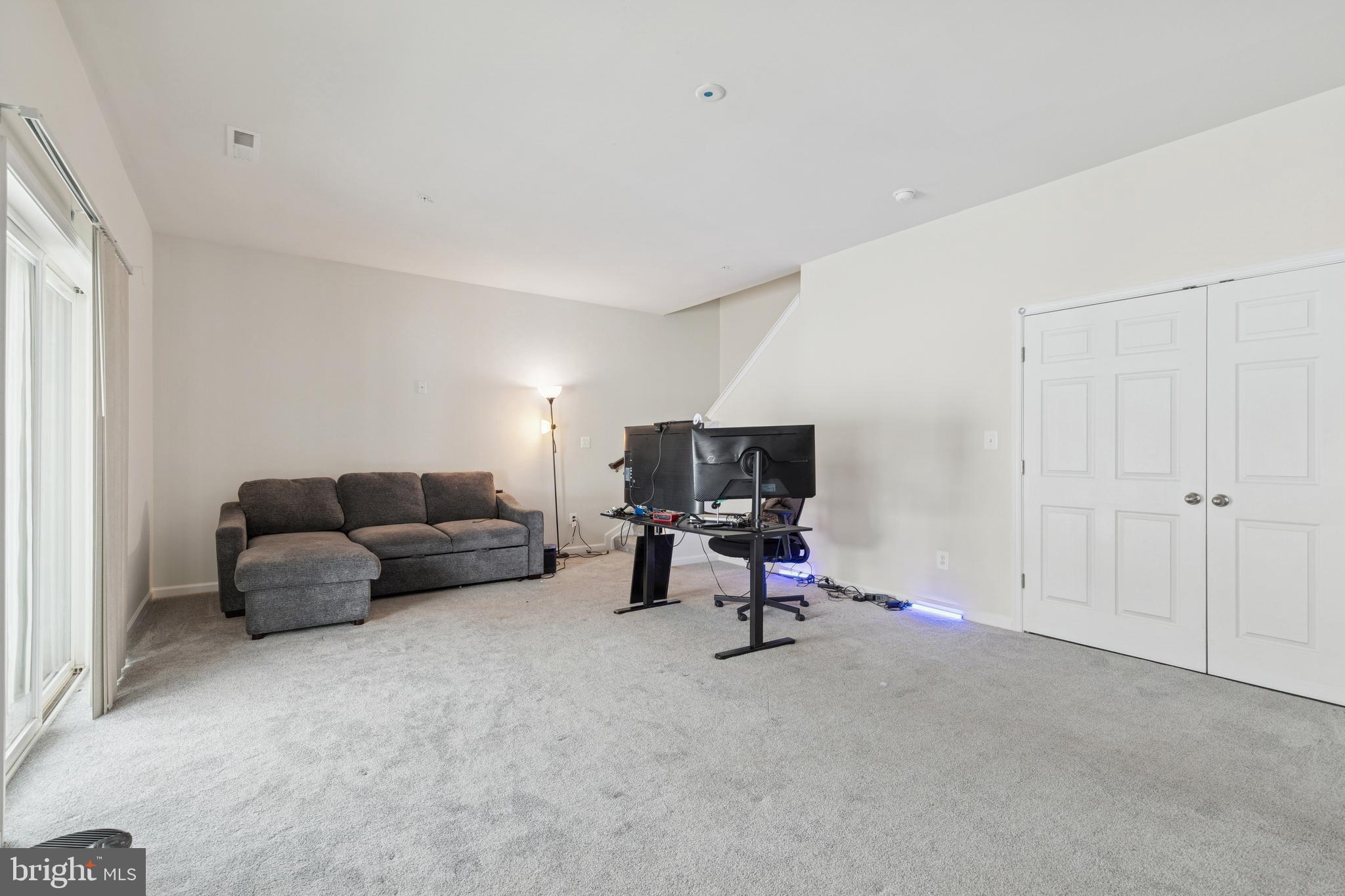 5857 Bella Marie Way, Unit F Frederick, MD 21703 - Photo 15 of 45 a living room with furniture and a couch