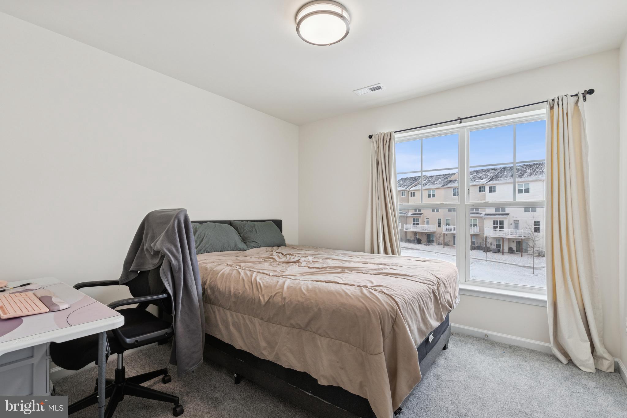 5857 Bella Marie Way, Unit F Frederick, MD 21703 - Photo 18 of 45 a bedroom with a bed a desk and chair