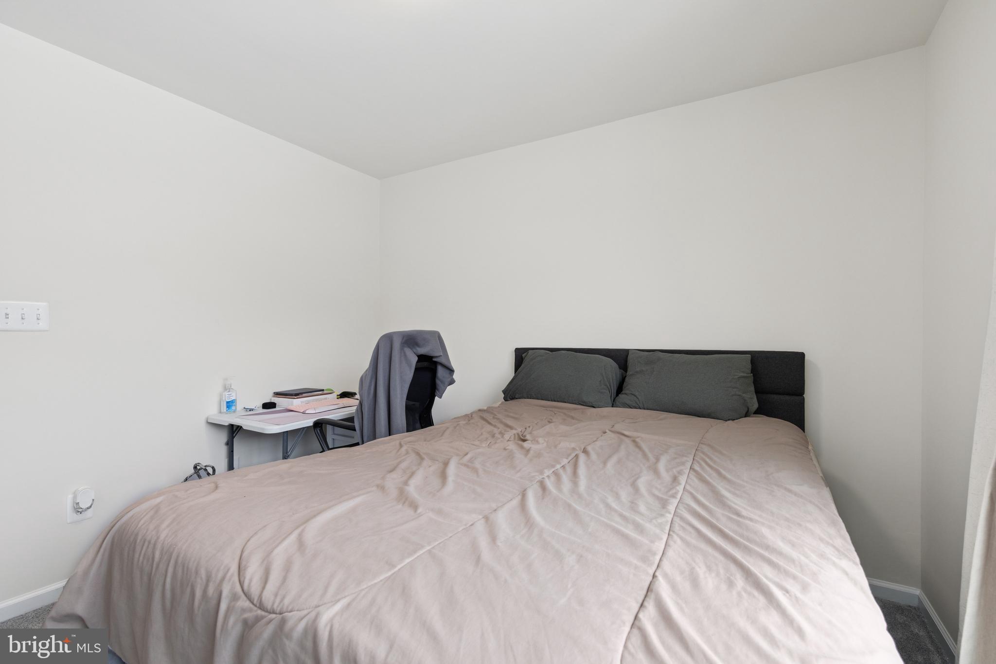 5857 Bella Marie Way, Unit F Frederick, MD 21703 - Photo 19 of 45 a large bed sitting in a bedroom next to a wall