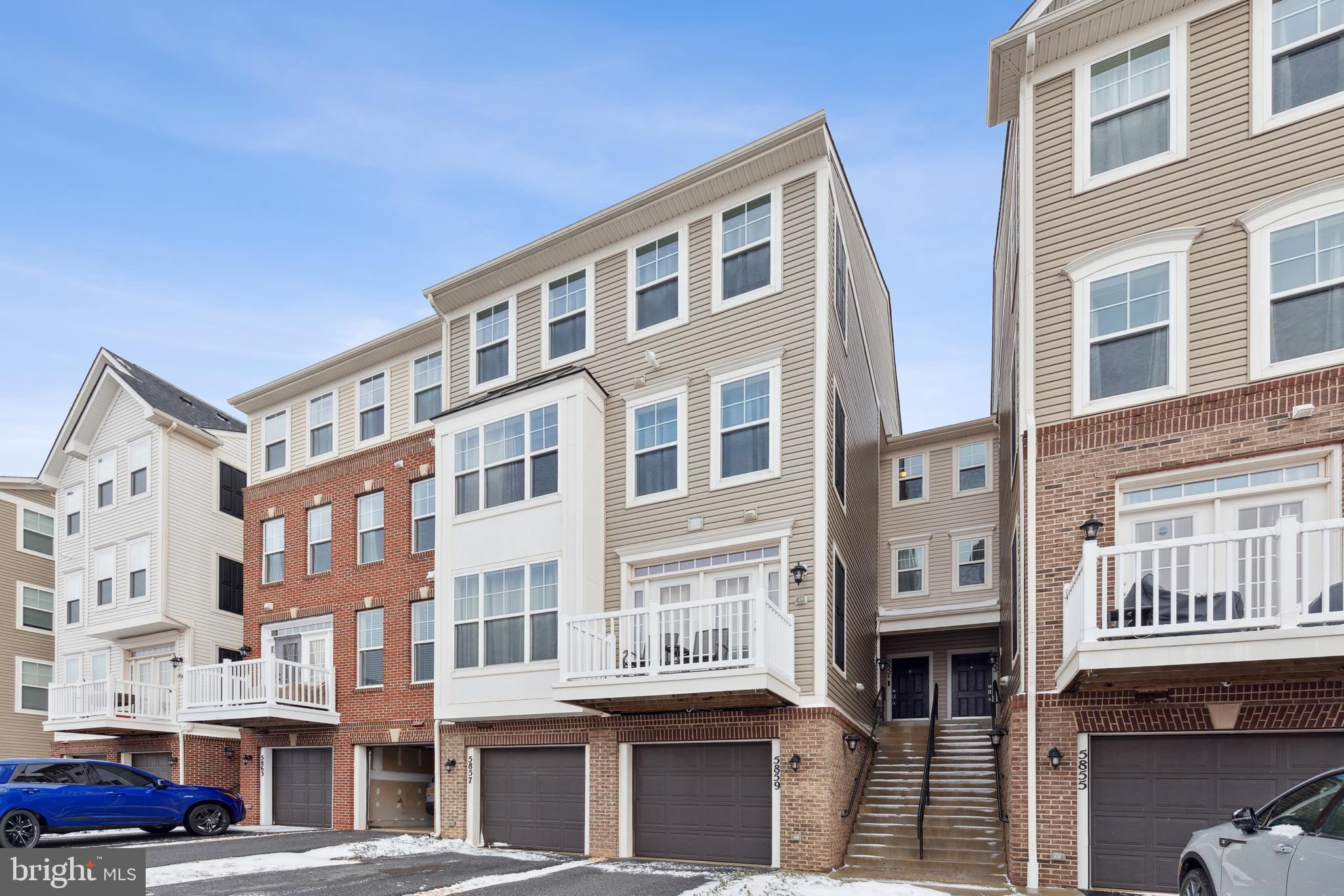 5857 Bella Marie Way, Unit F Frederick, MD 21703 - Photo 2 of 45 a front view of a building with lot of cars