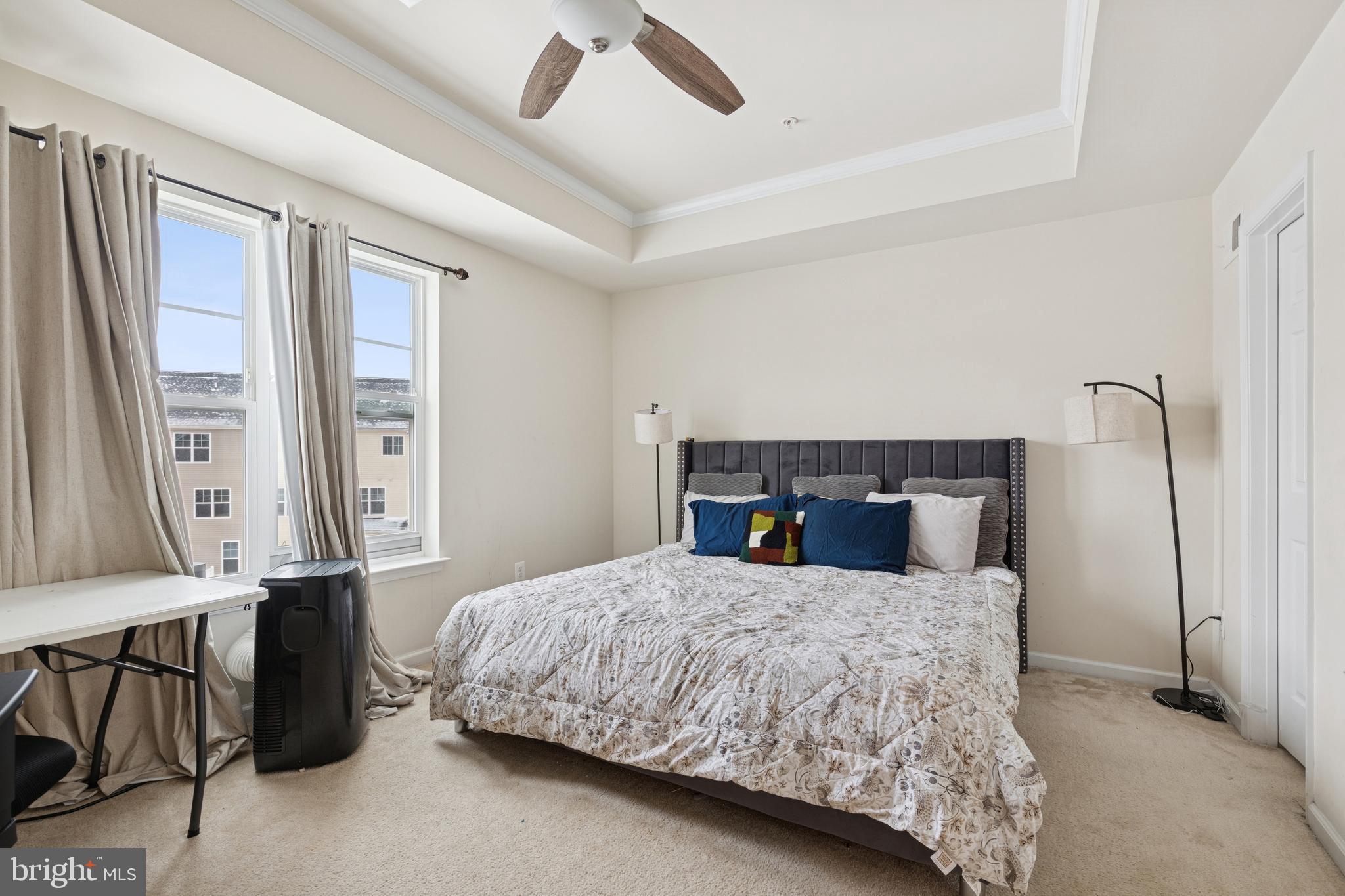 5857 Bella Marie Way, Unit F Frederick, MD 21703 - Photo 27 of 45 a bedroom with a large bed and a dresser
