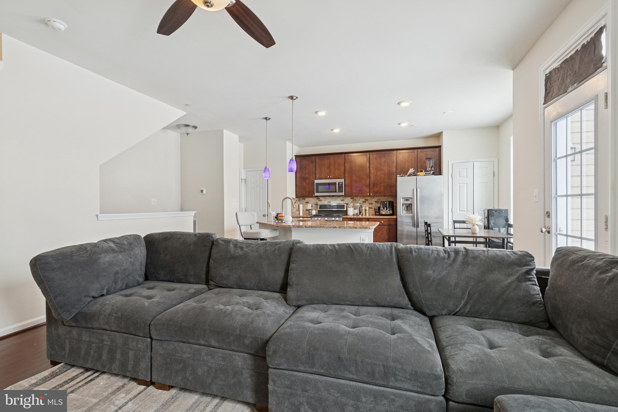 5857 Bella Marie Way, Unit F Frederick, MD 21703 - Photo 3 of 45 a living room with furniture and a large window