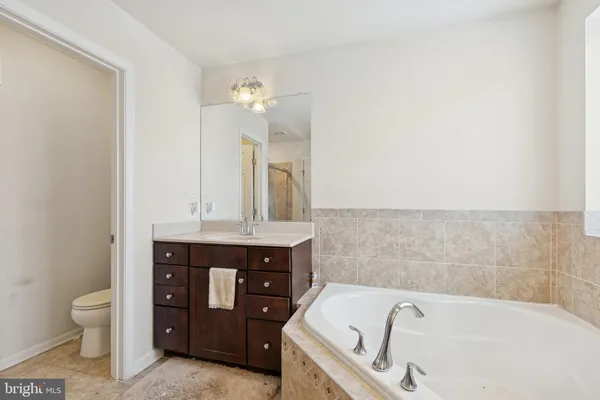 a bathroom with a tub sink and toilet