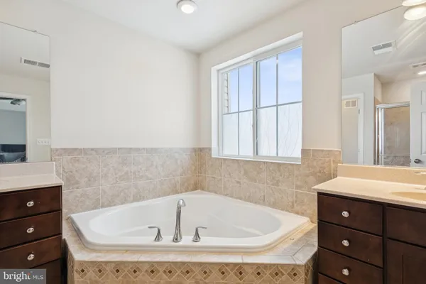 a bathroom with a bathtub and a sink