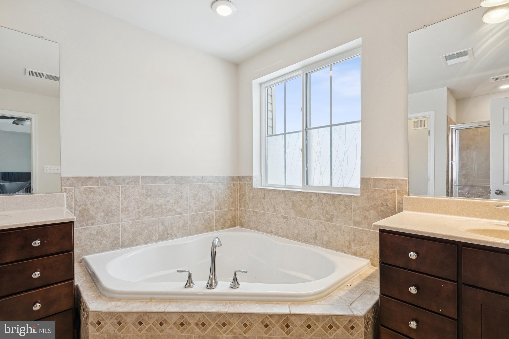 5857 Bella Marie Way, Unit F Frederick, MD 21703 - Photo 32 of 45 a bathroom with a bathtub and a sink