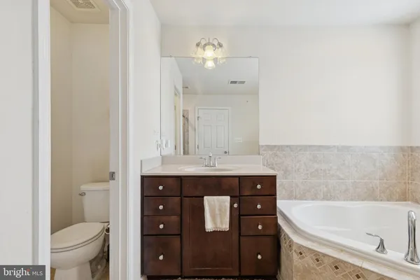 a bathroom with a sink a toilet and bathtub