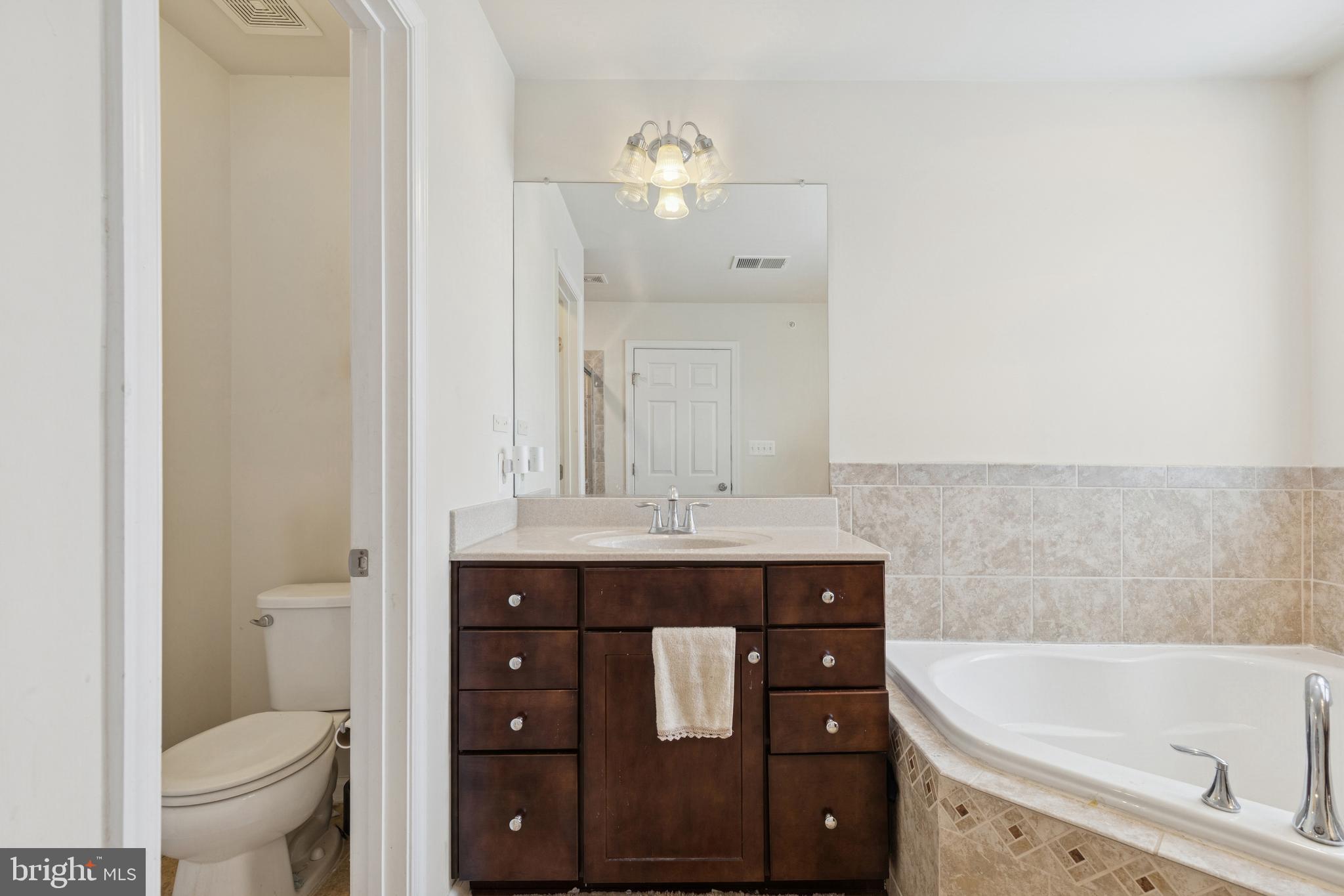 5857 Bella Marie Way, Unit F Frederick, MD 21703 - Photo 35 of 45 a bathroom with a sink a toilet and bathtub