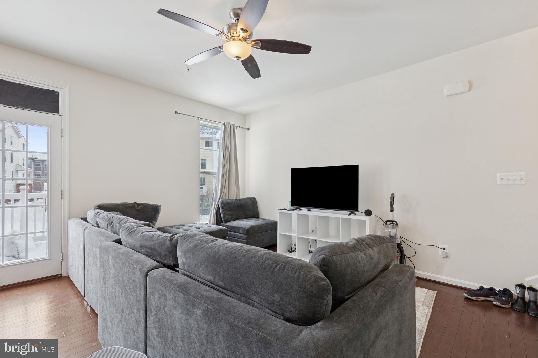 5857 Bella Marie Way, Unit F Frederick, MD 21703 - Photo 4 of 45 a living room with furniture and a flat screen tv