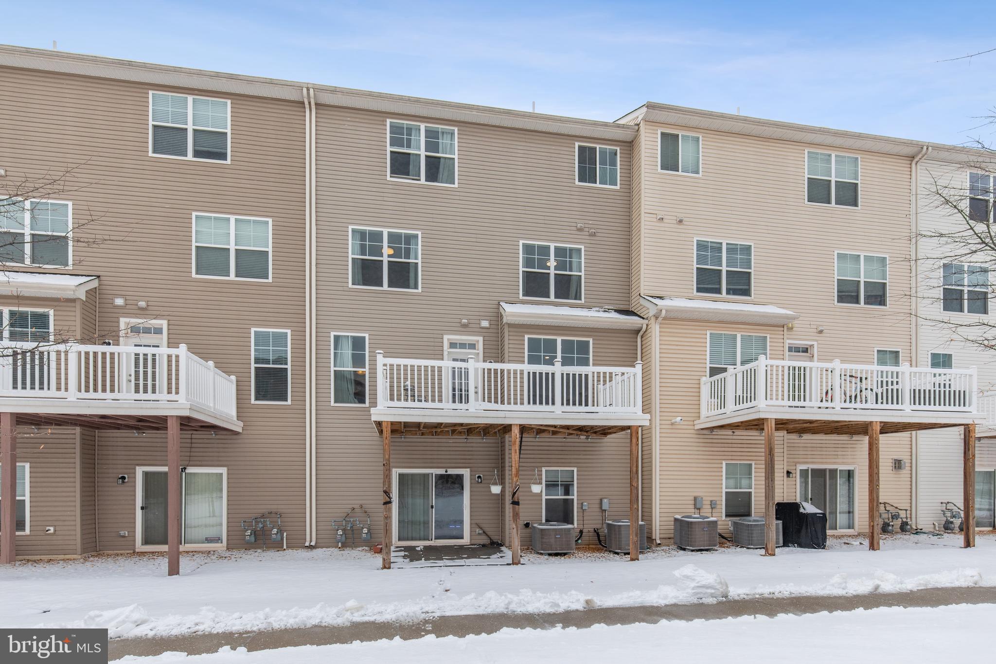 5857 Bella Marie Way, Unit F Frederick, MD 21703 - Photo 43 of 45 a front view of a building with a street
