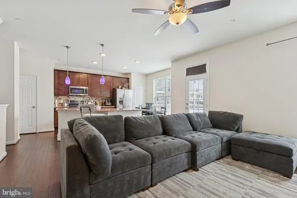 a living room with furniture and kitchen view