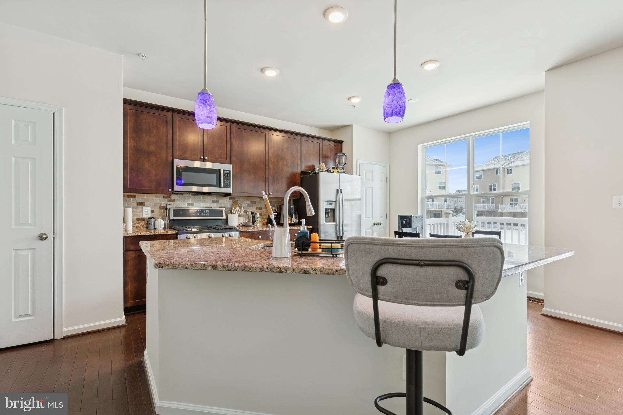 5857 Bella Marie Way, Unit F Frederick, MD 21703 - Photo 6 of 45 a kitchen with granite countertop a sink cabinets and window