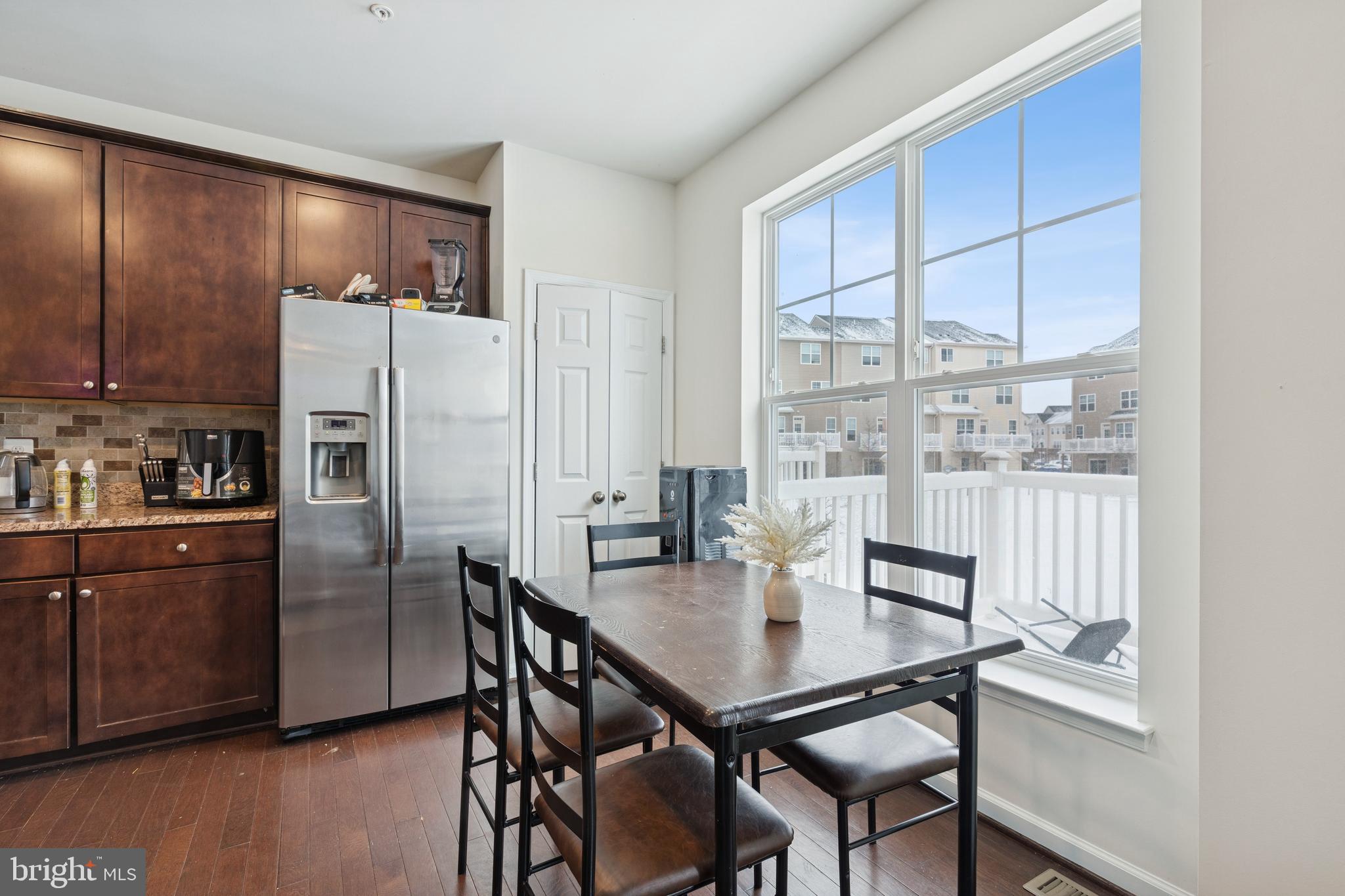 5857 Bella Marie Way, Unit F Frederick, MD 21703 - Photo 8 of 45 a kitchen with stainless steel appliances granite countertop a dining table and chairs