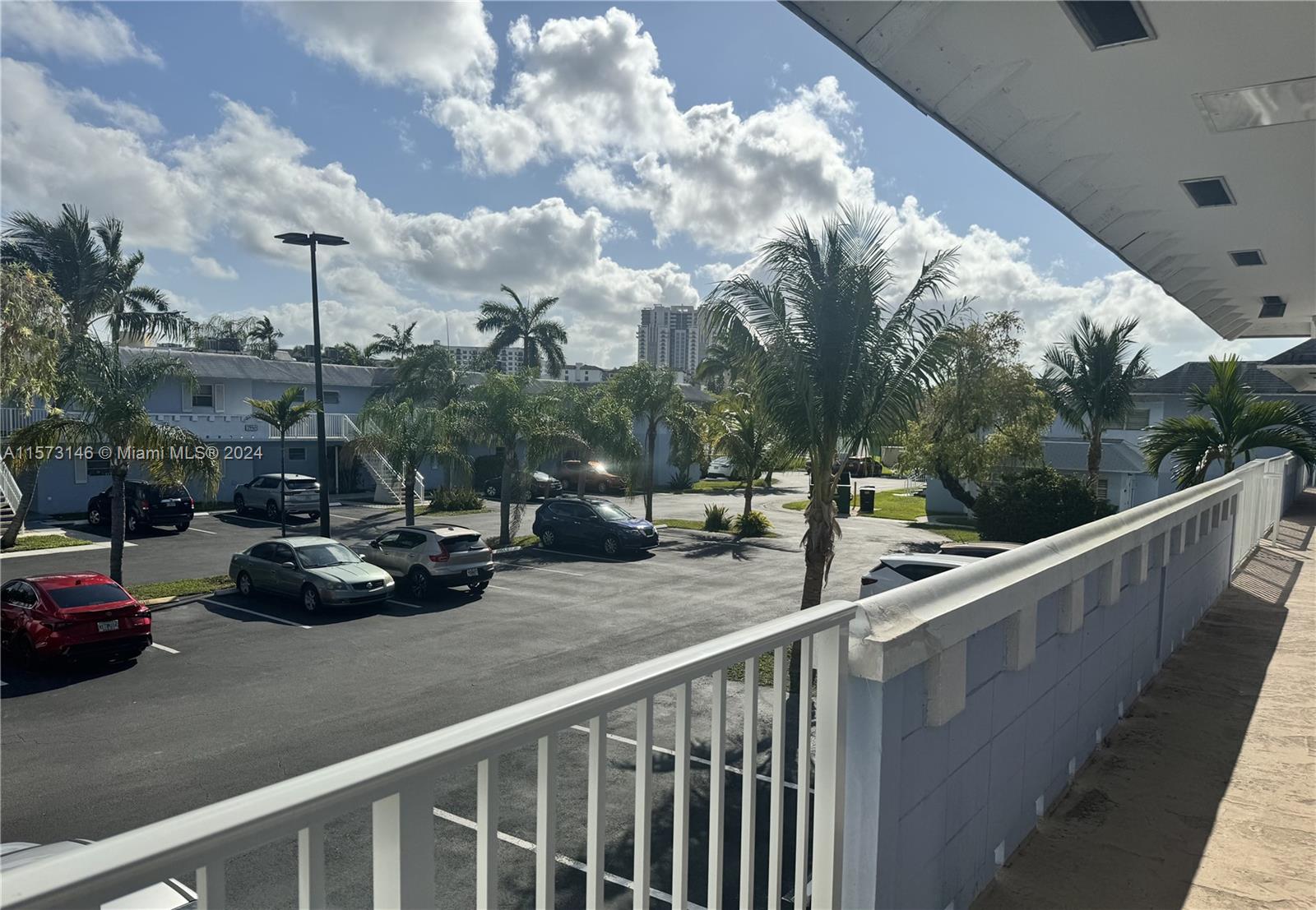 7580 Southwest 82nd Street, Unit F217 Miami, FL 33143 - Photo 13 of 14 a view of a roof deck with table and chairs with wooden fence