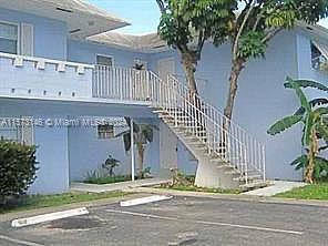 7580 Southwest 82nd Street, Unit F217 Miami, FL 33143 - Photo 14 of 14 a front view of a house with a garden