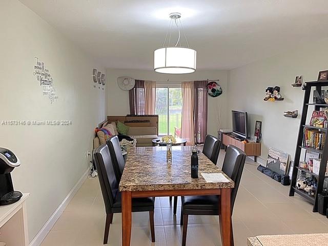 7580 Southwest 82nd Street, Unit F217 Miami, FL 33143 - Photo 3 of 14 a view of a dining room with furniture