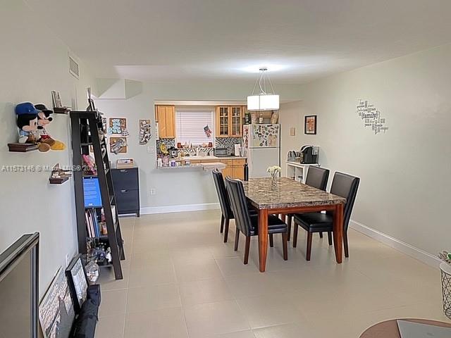 7580 Southwest 82nd Street, Unit F217 Miami, FL 33143 - Photo 4 of 14 a view of a dining room with furniture
