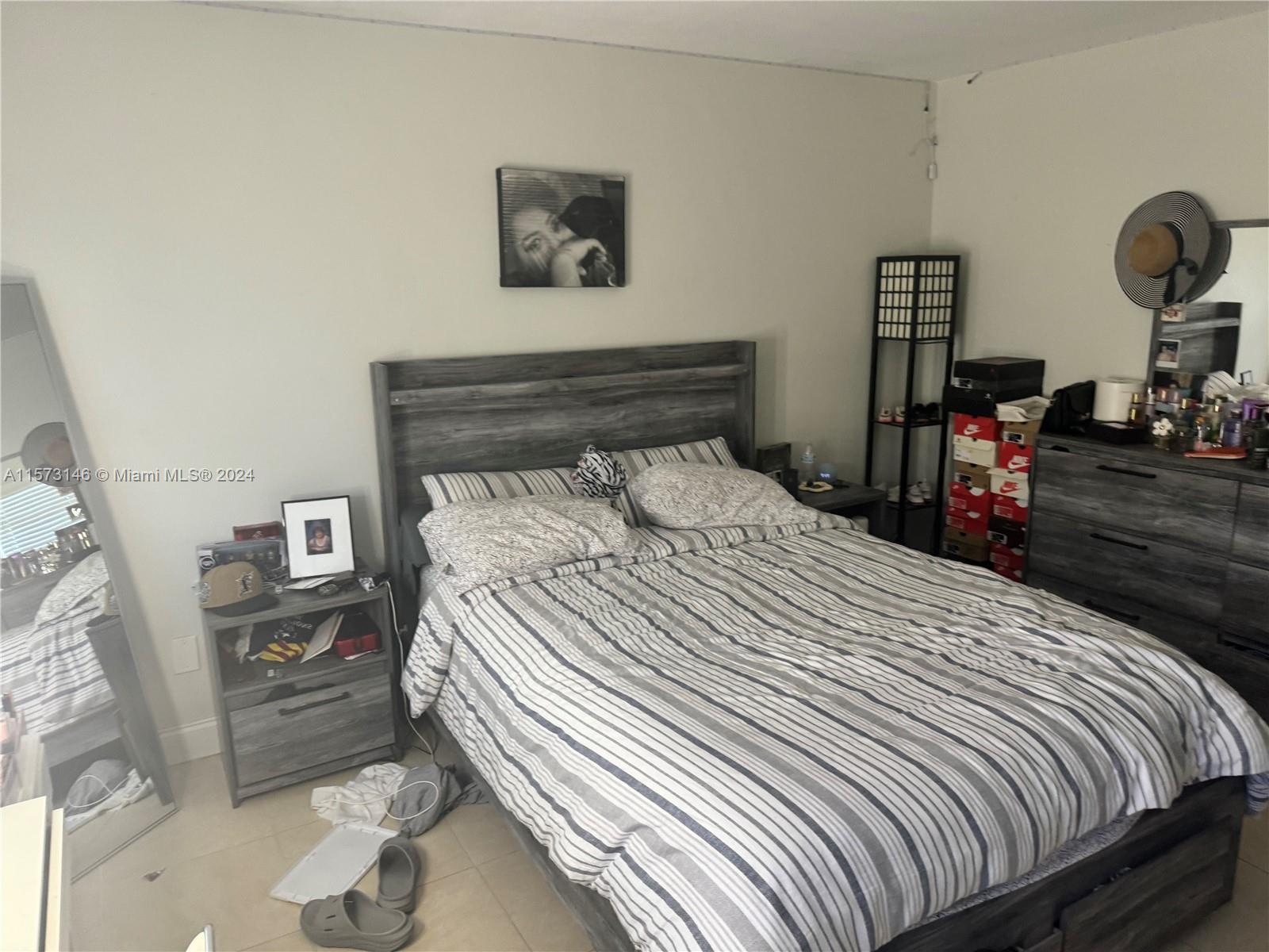 7580 Southwest 82nd Street, Unit F217 Miami, FL 33143 - Photo 5 of 14 a bedroom with a bed and wooden floor